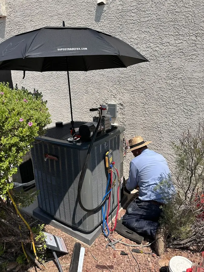 HVAC technician performing outdoor AC maintenance in Chino